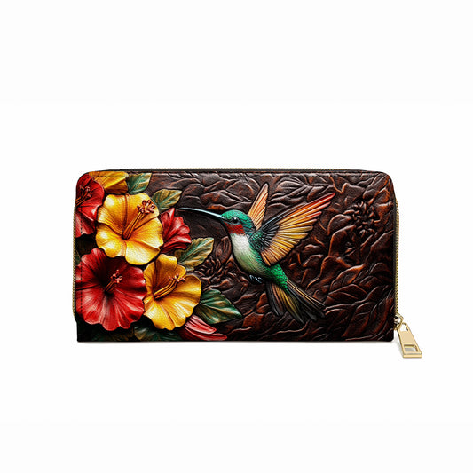 Glänzende Clutch aus Leder mit Trageriemen und Kolibri-Blüte