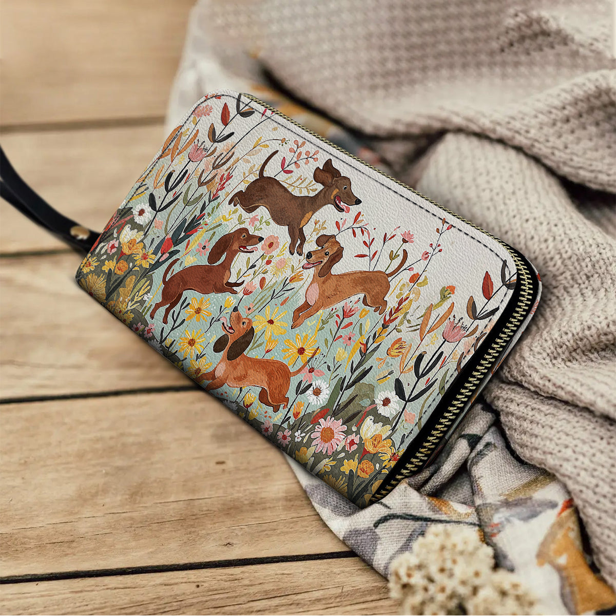 Pochette en cuir brillante avec dragonne et poignée motif teckel floral