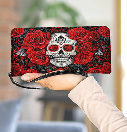 Pochette en cuir brillant avec dragonne et poignée élégante en forme de tête de mort et de roses rouges