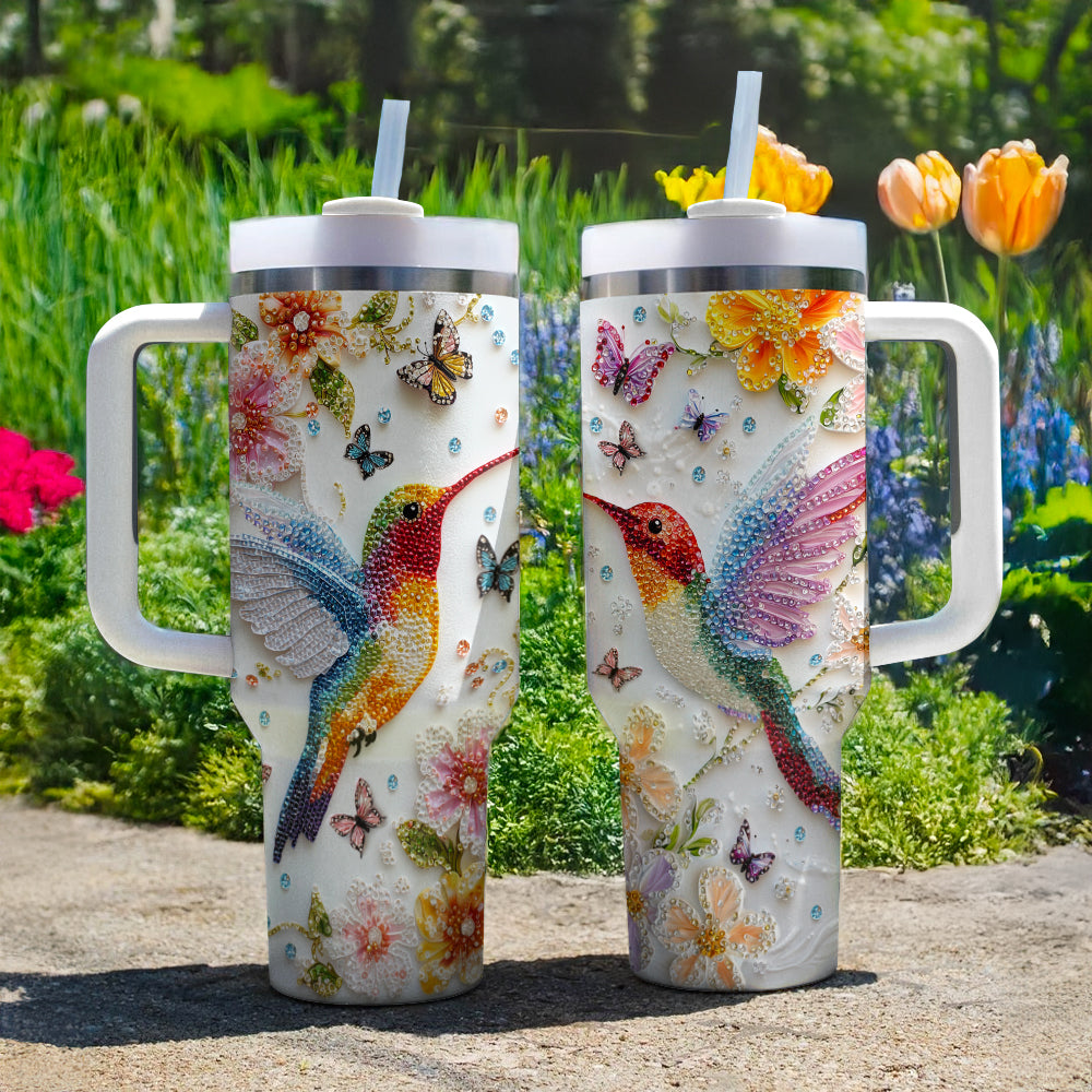 Glänzender, glänzender Becher mit Blumen-Kolibri und Schmetterlingen