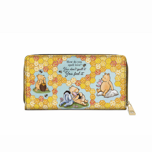 Pochette en cuir brillante avec dragonne et citation Winnie l'ourson